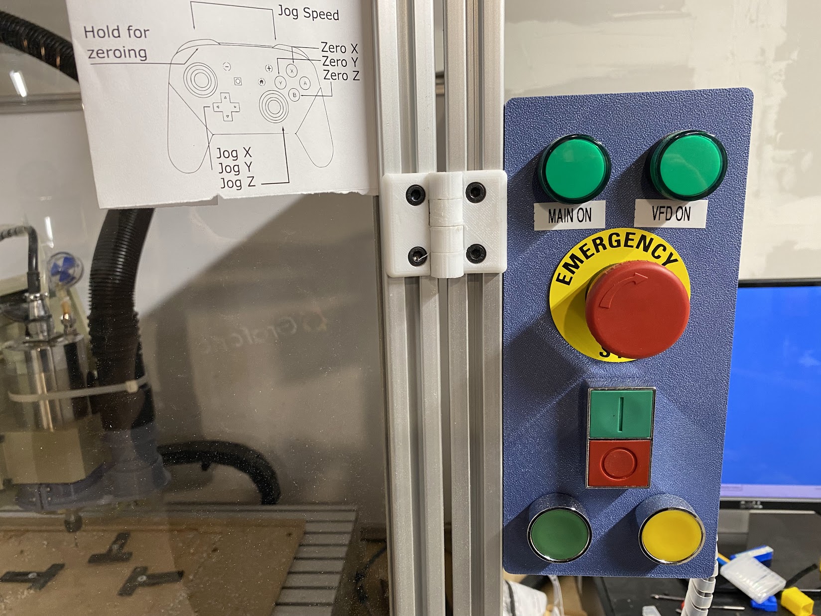 Enclosure panel with control buttons and emergency stop